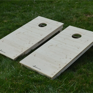 cornhole 2 planches bois naturel avec veinage et nœuds apparents, sur le gazon, vue de face