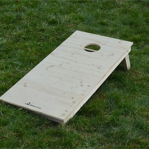 cornhole bois naturel avec veinage et nœuds apparents, sur le gazon, vue de face